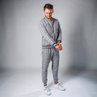 Man wearing grey check tracksuit with striped zip jacket and joggers | Chaps London