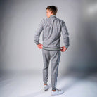 Man wearing grey check tracksuit with striped trim, zip jacket and joggers, back view | Chaps London