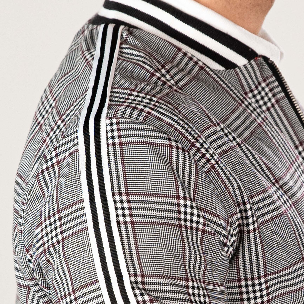 Black and white check track jacket with striped collar, worn by person | Chaps London