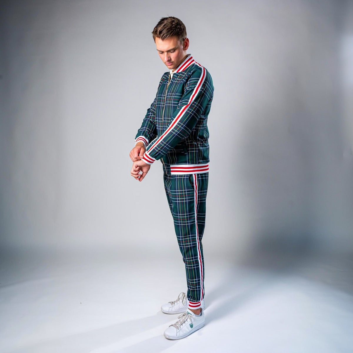 Man wearing green plaid tracksuit with red and white stripe detailing | Chaps London