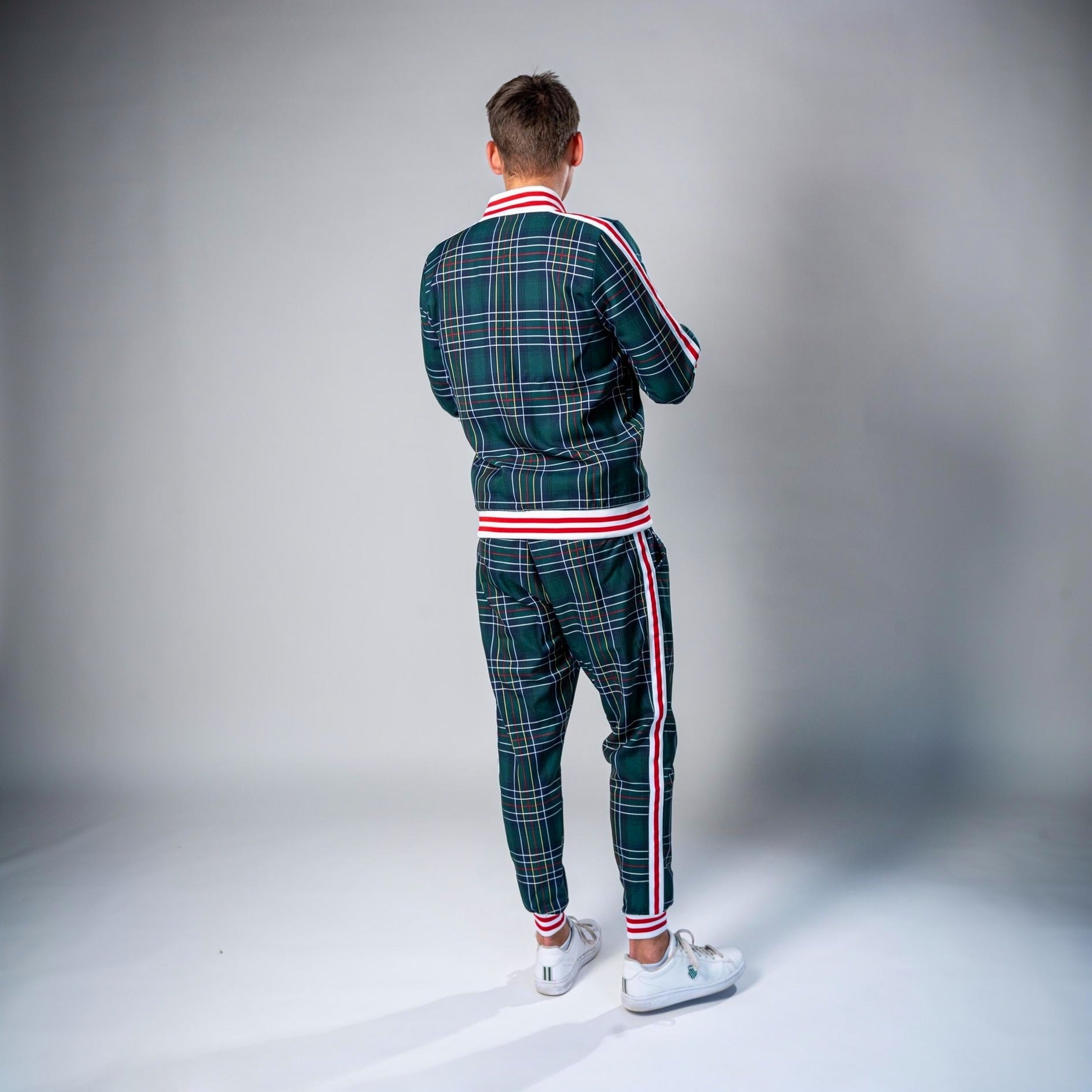 Man wearing green plaid tracksuit with red white striped trim, rear view | Chaps London