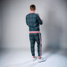 Man wearing green plaid tracksuit with red white striped trim, rear view | Chaps London