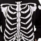 Black zip-up hoodie with white skeleton rib cage print, worn by person | Chaps London