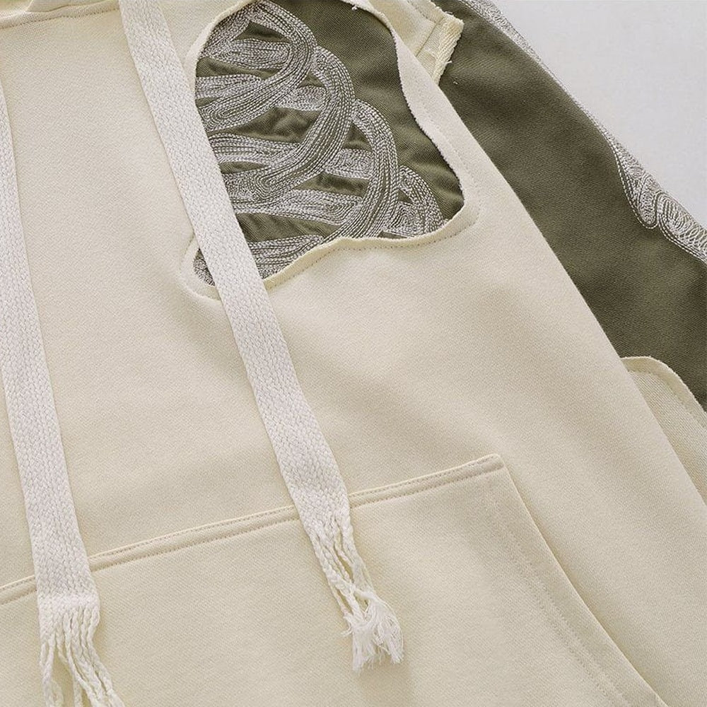 Close-up of cream hoodie with embroidered bone pattern and drawstrings | Chaps London
