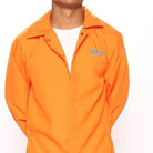 Orange prisoner jumpsuit worn by man, partially unzipped, front view closeup | Chaps London