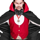 Man wearing black cape, red vest, black bow tie, and medallion | Chaps London
