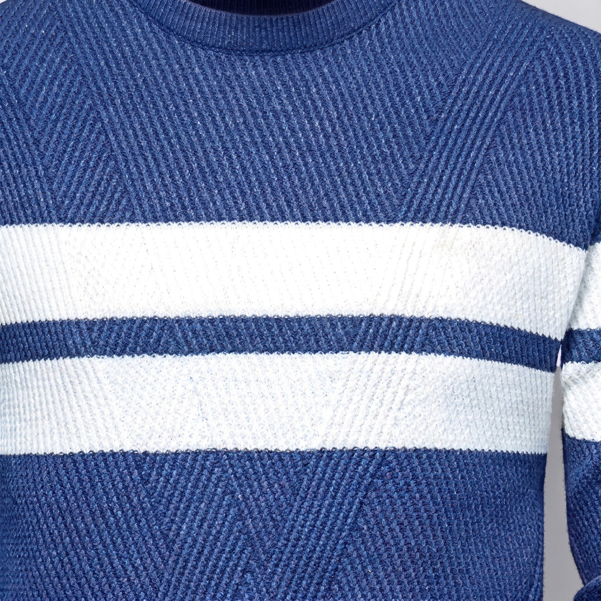 Blue knitted jumper with white block stripes, worn by person, close-up view | Chaps London