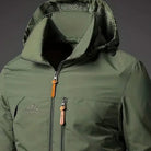 Olive green hooded windbreaker jacket with zippers, worn by a person | Chaps London