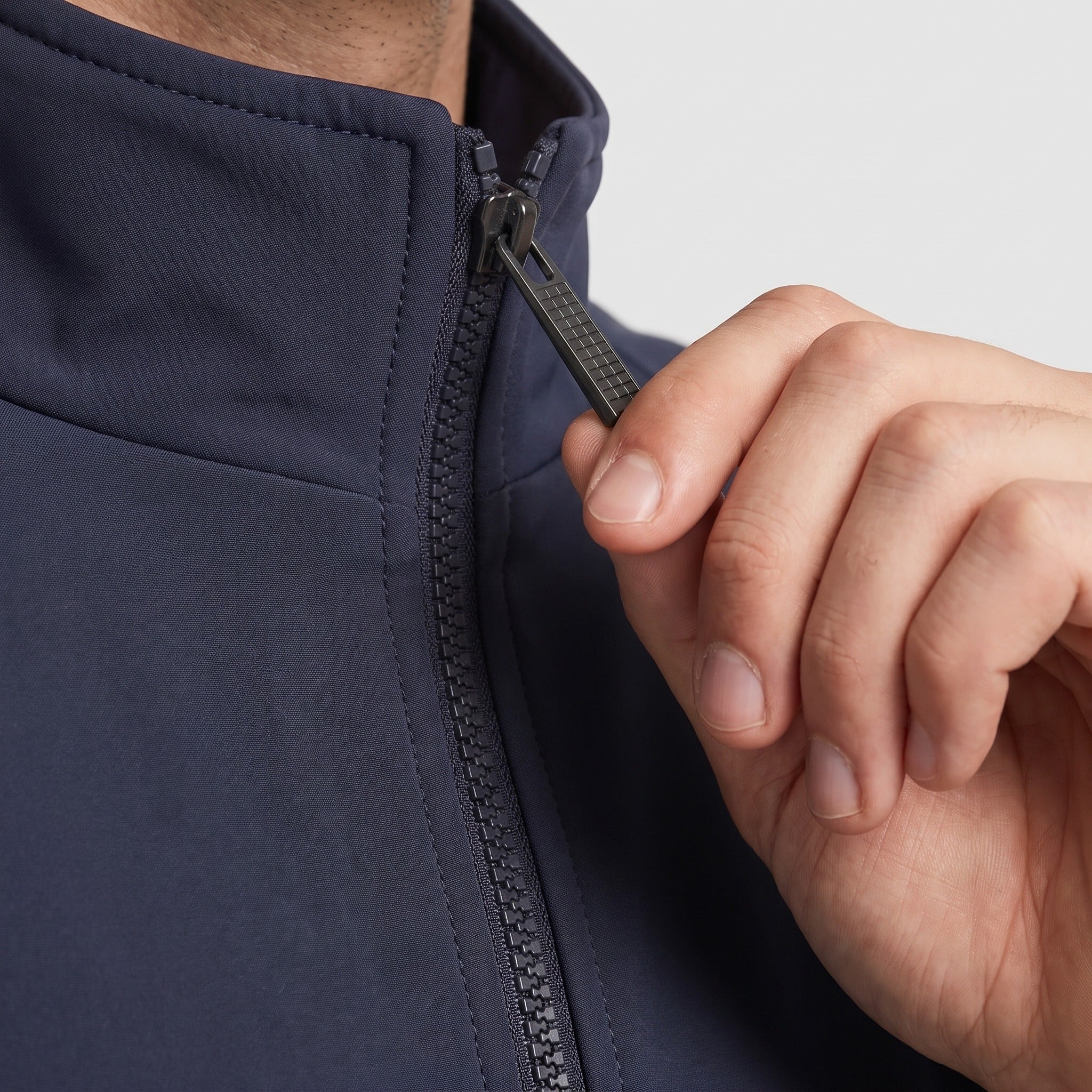 Close-up of navy jacket stand collar zipper being worn by person | Chaps London