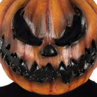 Orange pumpkin mask with evil face worn by a person | Chaps London