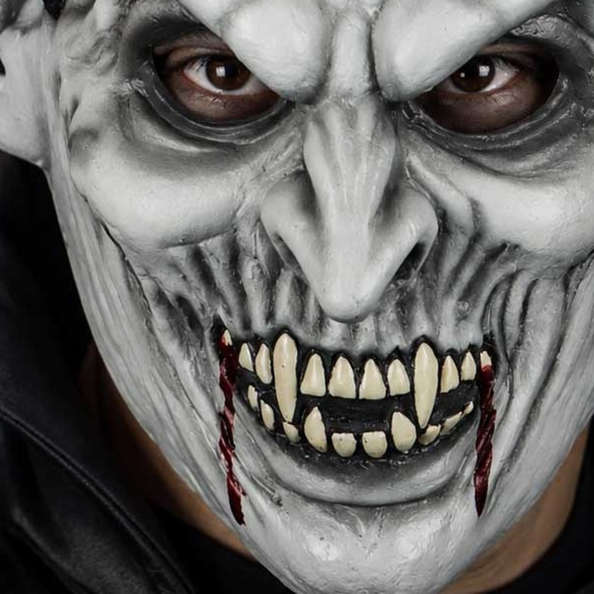 Grey vampire mask worn by person, bloody fangs and wrinkled texture | Chaps London