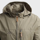 Olive green hooded rain jacket with zip pockets, worn by person | Chaps London