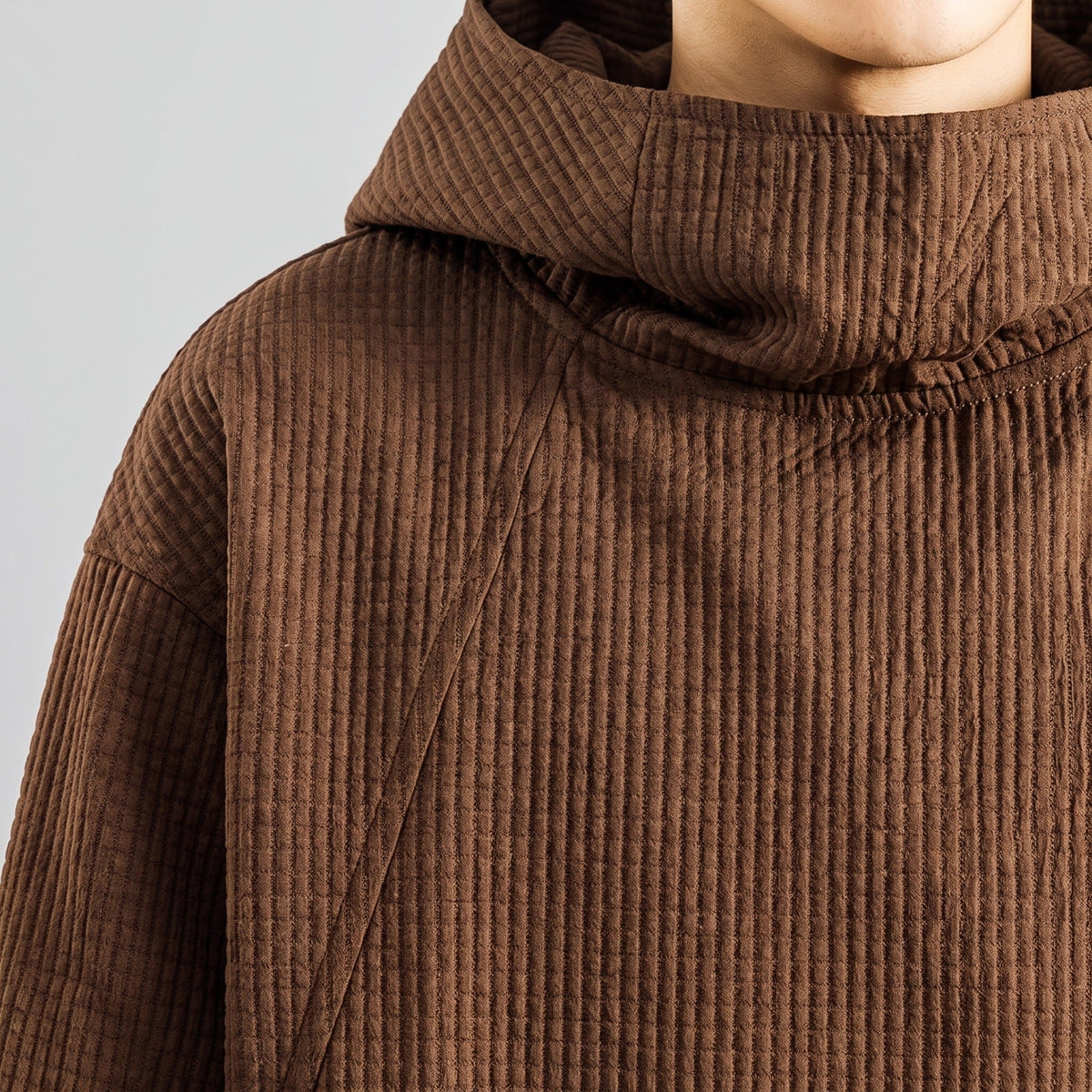 Brown waffle-textured oversized hoodie with funnel neck, worn by person, close-up view | Chaps London