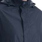Navy blue hooded rain jacket worn by person, close-up on zipper | Chaps London