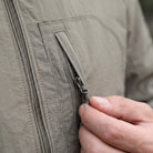 Worn olive green jacket, close-up on zipper pull and chest pocket detail | Chaps London