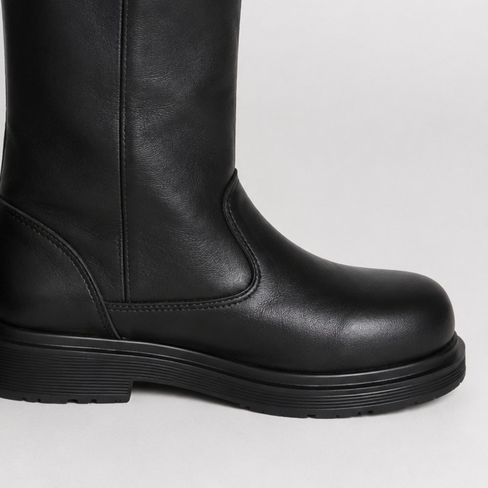 Black leather mid-calf boot, close-up view, worn on person's leg | Chaps London