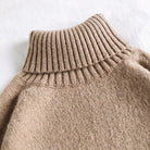 Tan ribbed turtleneck sweater knit fabric close-up, flat lay detail shot | Chaps London