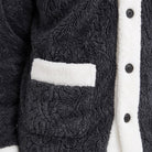 Close-up of dark grey coral fleece jacket with white trim and pocket | Chaps London
