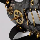 Black steampunk half mask with gold gears, spikes, and rivets, close-up view | Chaps London