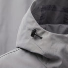 Gray rain jacket close-up showing hood collar and toggle drawstring detail | Chaps London