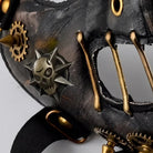 Black and gold steampunk half mask with gears, spikes, and skull detail | Chaps London
