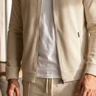 Beige waffle-texture zip jacket worn by man, paired with matching sweatpants | Chaps London
