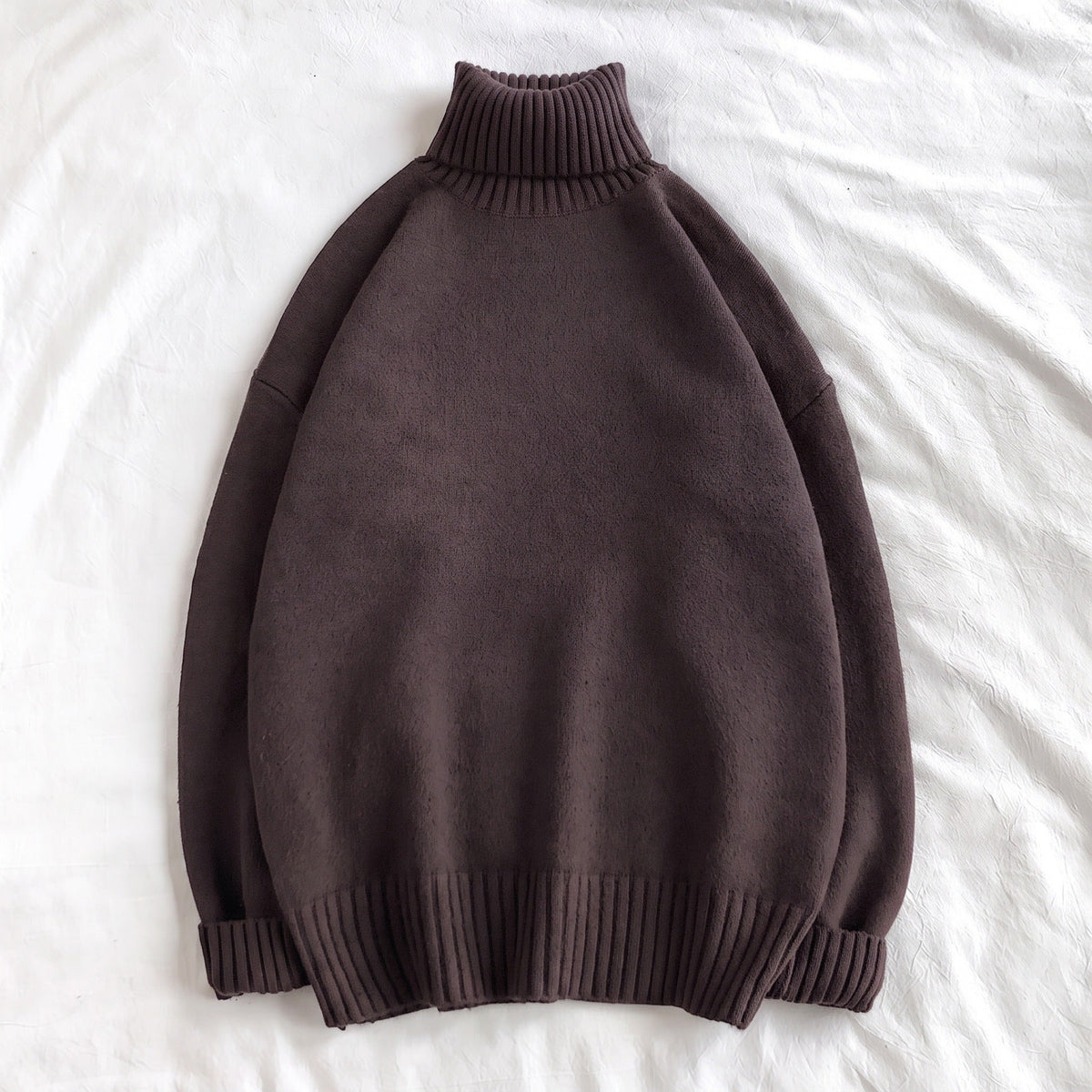 Dark brown oversized turtleneck sweater, knit fabric, laid flat on white background | Chaps London