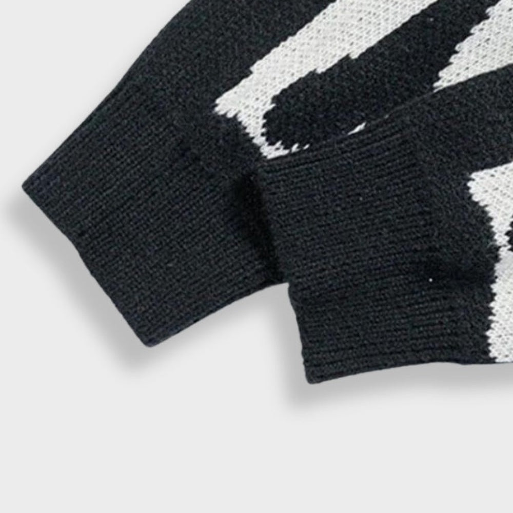 Black and white knit sweater cuffs with ribbed texture, close-up flat view | Chaps London