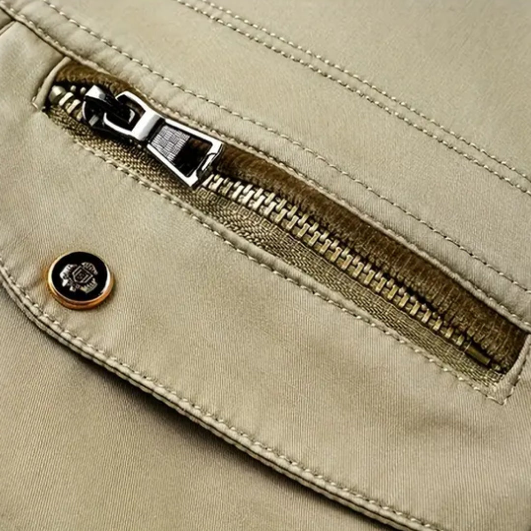 Beige cotton jacket pocket with zipper and snap button detail close-up | Chaps London