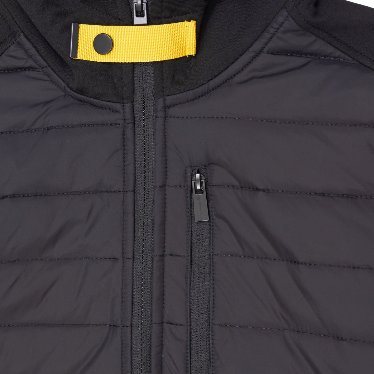 Close-up of black quilted jacket zipper and chest pocket detail | Chaps London