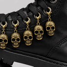 Gold skull charms with lobster clasps attached to black boot laces | Chaps London