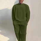 Man wearing olive green textured knit sweater and matching trousers, worn outdoors | Chaps London