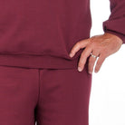 Maroon fleece sweatshirt and joggers worn by person, close-up waist view | Chaps London