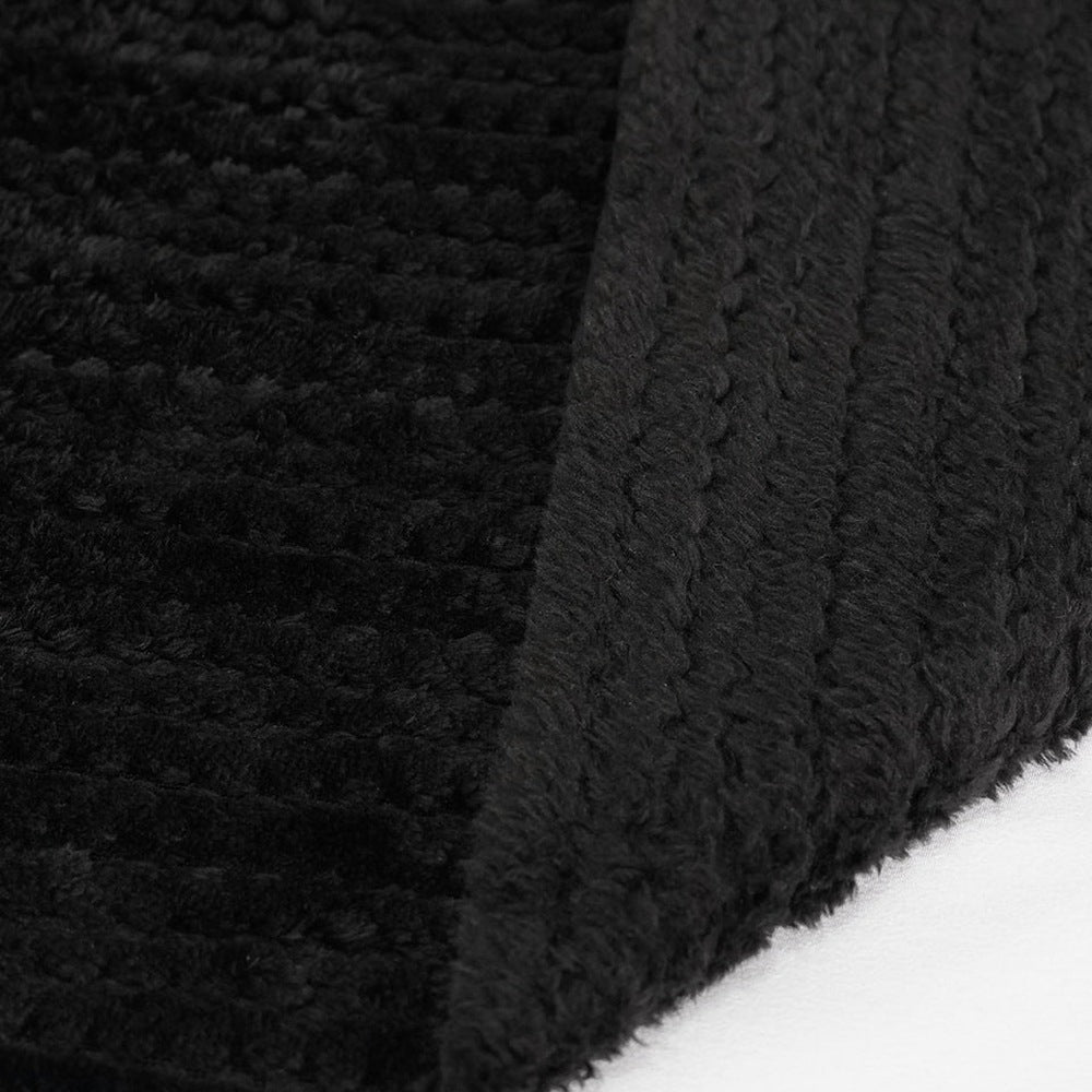 Black chenille fabric close-up showing folded texture and ribbed edge detail | Chaps London
