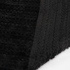 Black chenille fabric close-up showing folded texture and ribbed edge detail | Chaps London