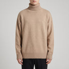 Man wearing beige oversized roll neck jumper with ribbed knit detailing | Chaps London