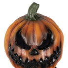 Orange jack-o-lantern mask with menacing carved face, worn by a person | Chaps London