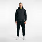 Man wearing black quilted hooded jacket with matching joggers and white sneakers | Chaps London