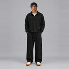 Man wearing black ribbed collared top and wide-leg trousers, full outfit | Chaps London