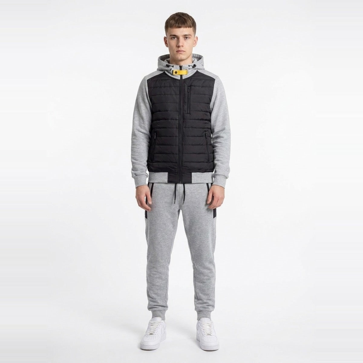 Man wearing black quilted hooded vest jacket with grey jogger sweatpants | Chaps London