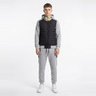 Man wearing black quilted hooded vest jacket with grey jogger sweatpants | Chaps London