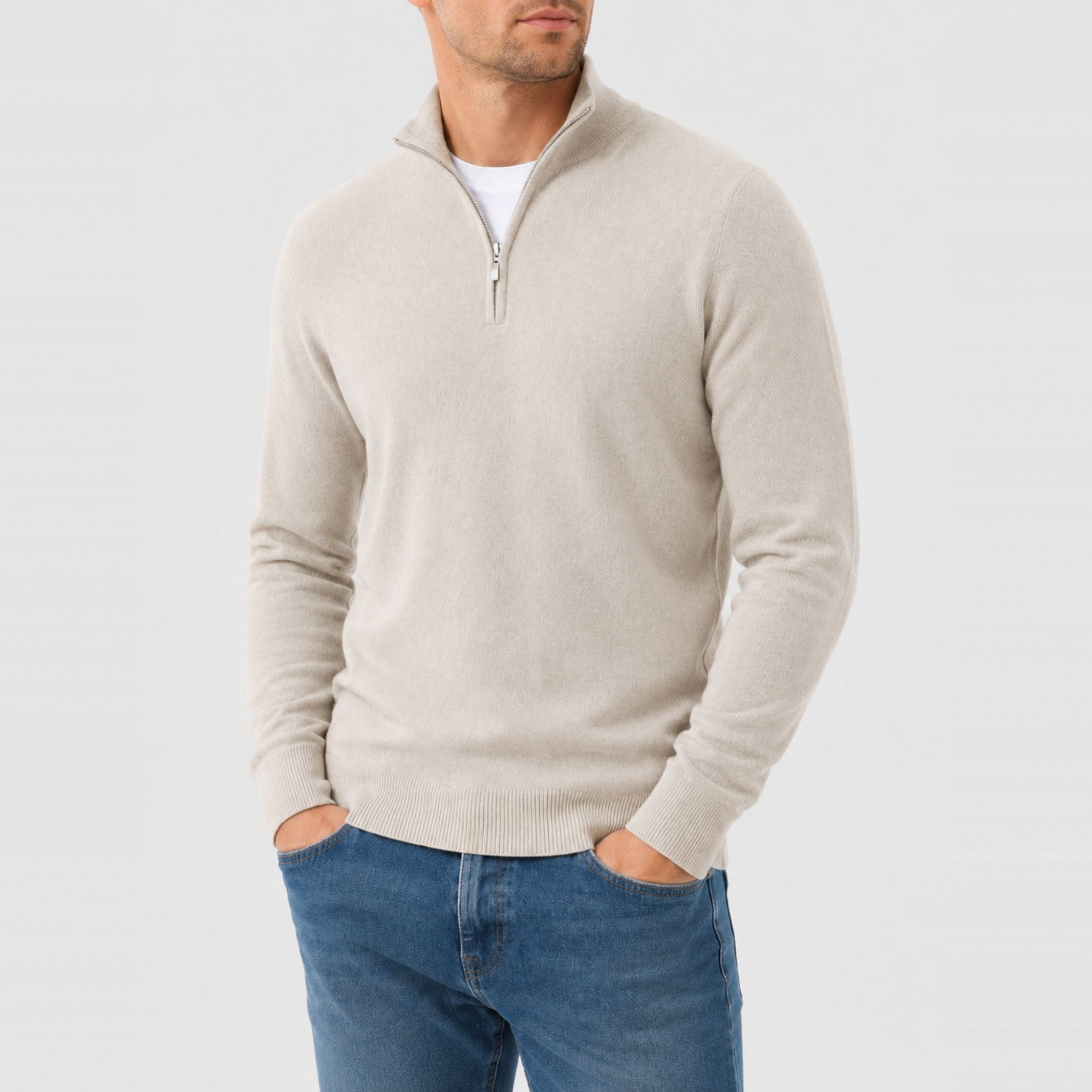 Man wearing beige quarter zip sweater with stand collar and blue jeans | Chaps London