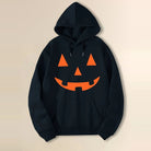 Black hoodie with orange jack-o-lantern face print, shown flat on background | Chaps London