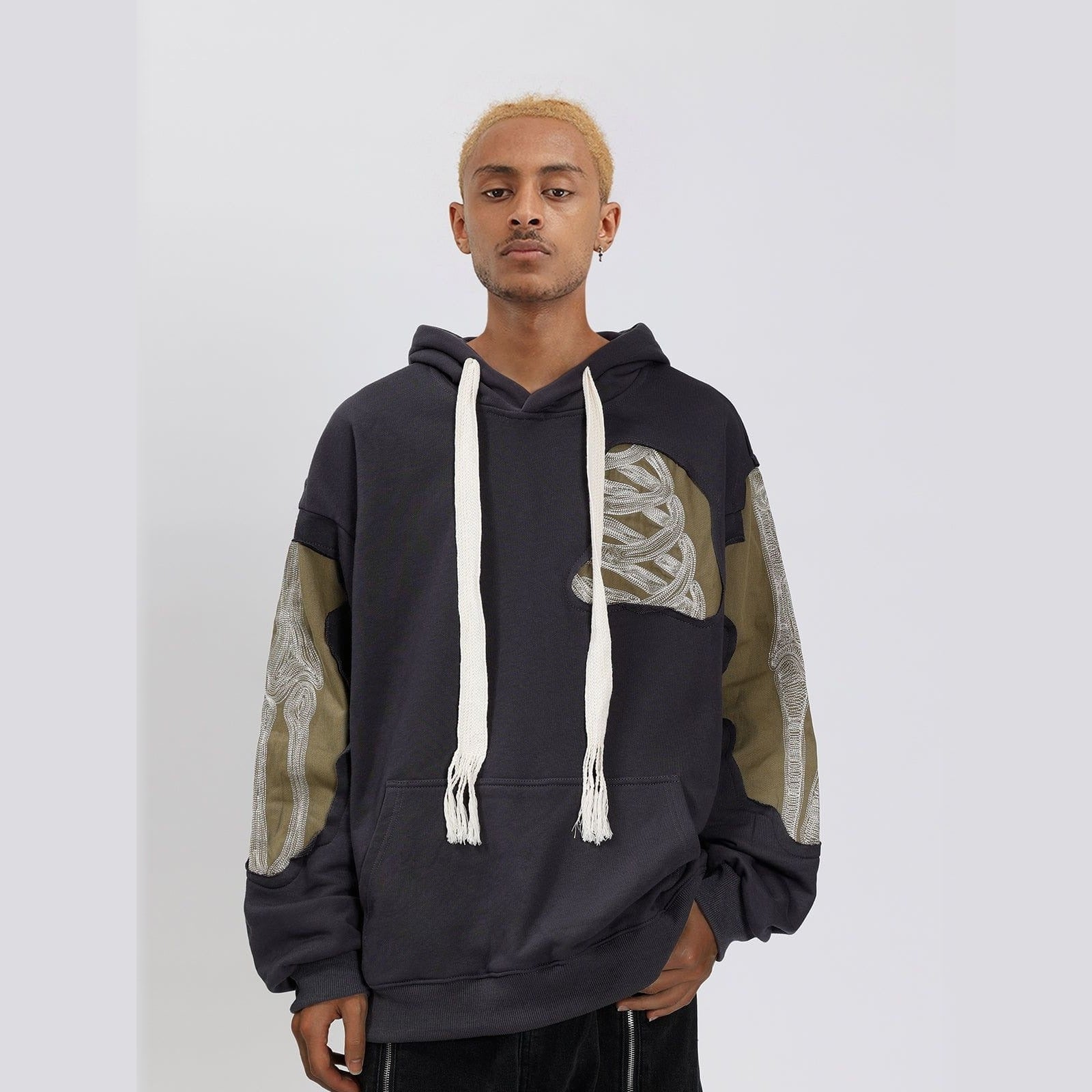 Worn by man, dark gray hoodie with olive patchwork, oversewn skeleton embroidery details | Chaps London