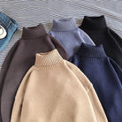 Five oversized turtleneck knit sweaters in assorted solid colors, laid flat | Chaps London