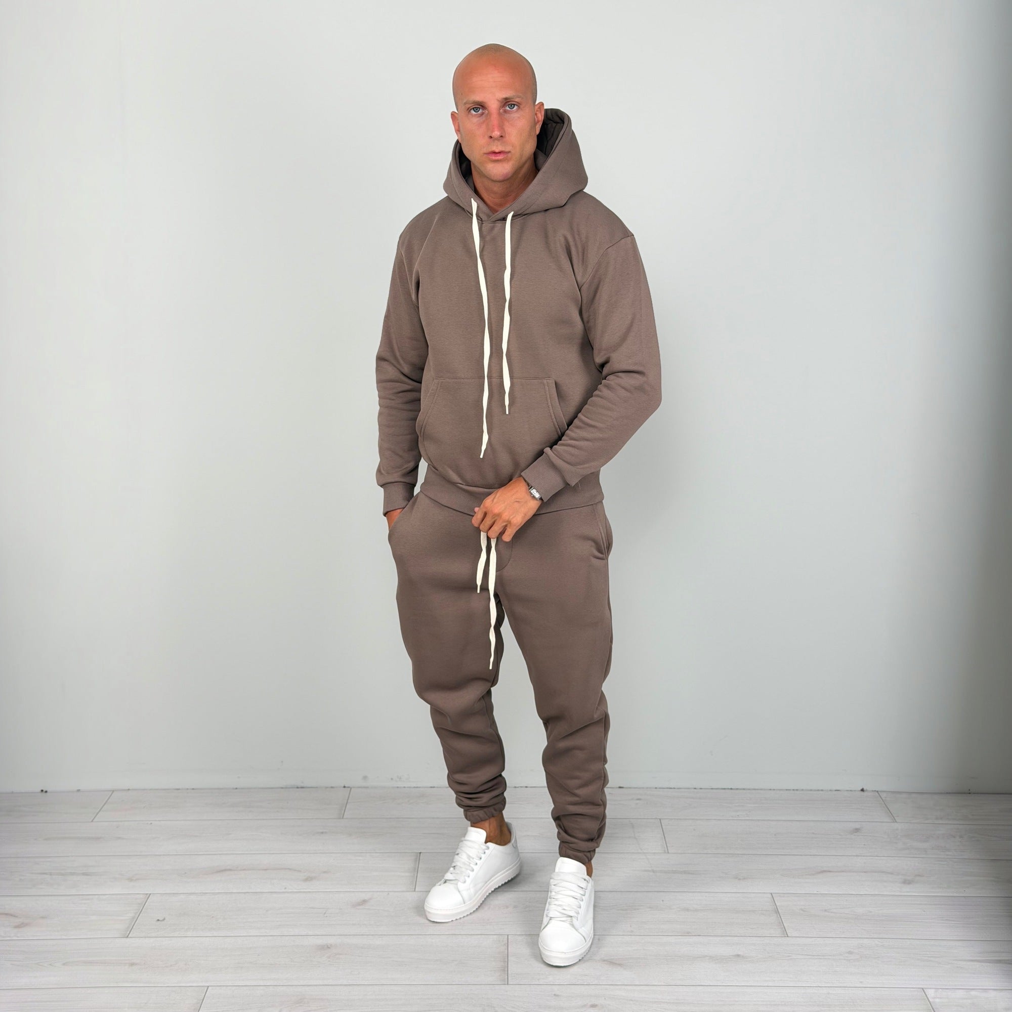 Man wearing brown hoodie tracksuit with cuffed joggers and white sneakers | Chaps London