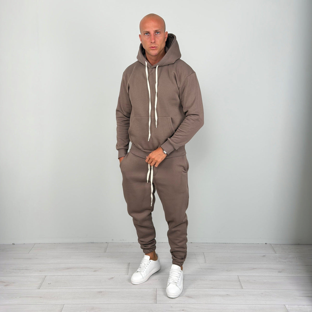 Man wearing brown hoodie tracksuit with cuffed joggers and white sneakers | Chaps London