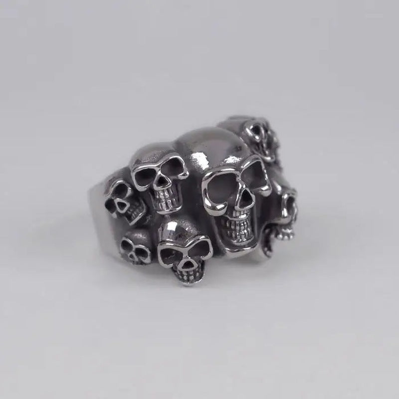 Silver-toned multiple skull cluster ring shown flat against plain background | Chaps London