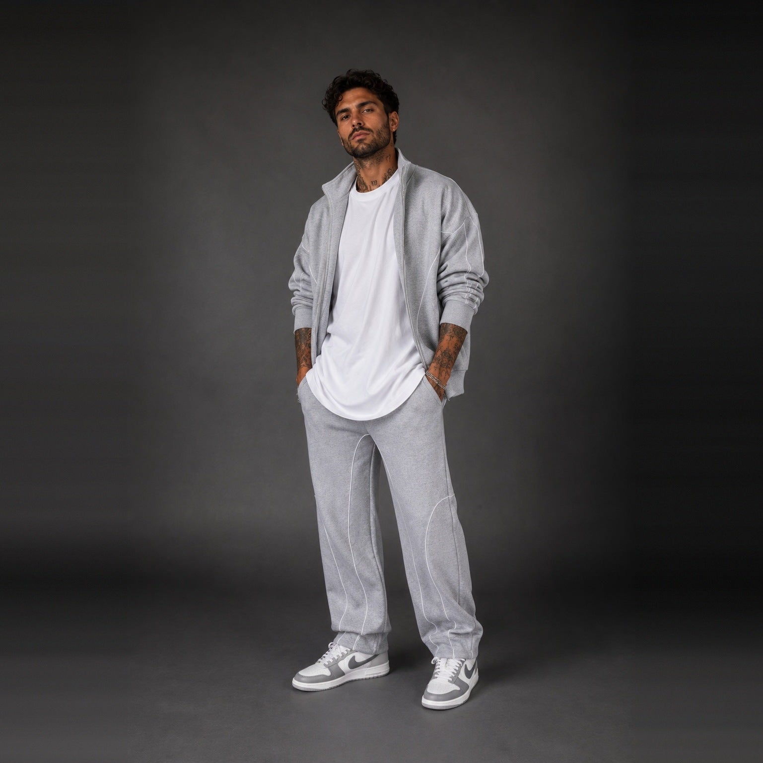Man wearing light grey zip jacket, white t-shirt, and matching grey sweatpants | Chaps London