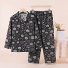 Black pyjama set with pumpkin print, hanging on display, pants shown flat | Chaps London